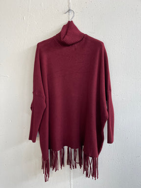 Pull collo alto con frange